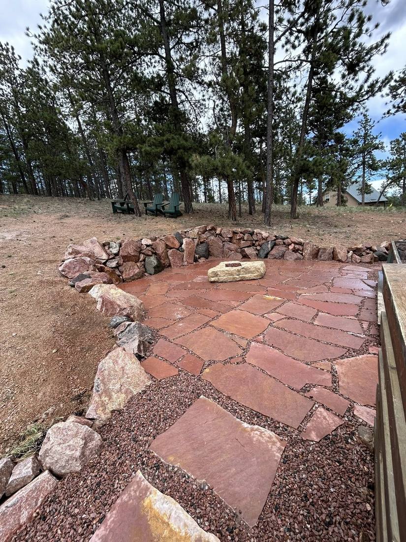 Natural boulder retaining wall with integrated stone steps