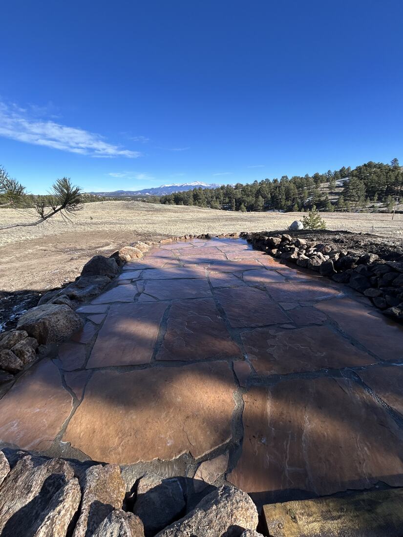 Flagstone patio bordered by boulders overlooking the high country