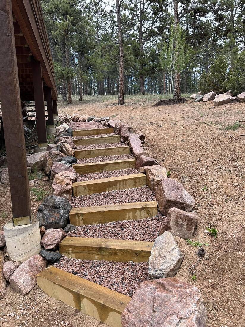 Long timber and boulder stairway through pine forest