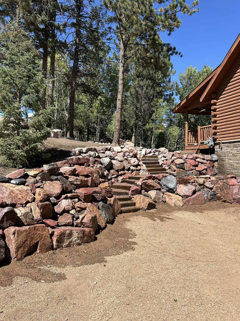 Flagstone and boulder xeriscape entry with native rock bed